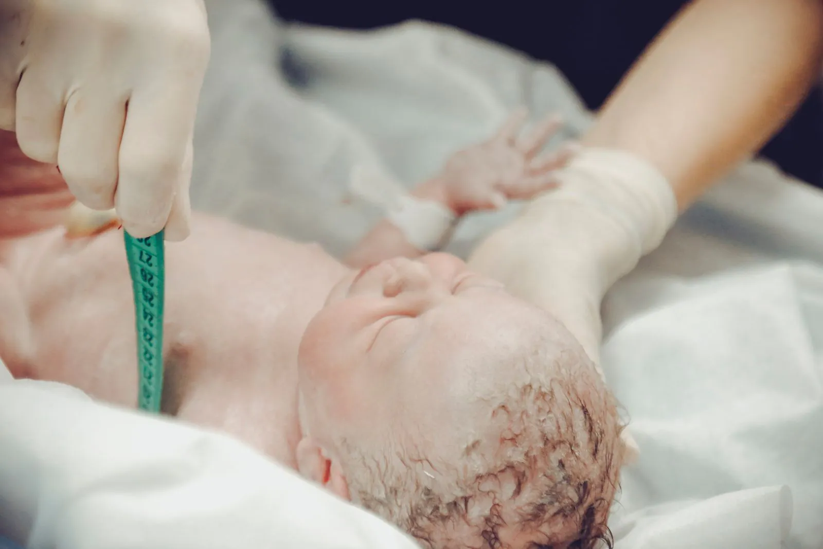 Medical professional measuring a newborn baby in a hospital